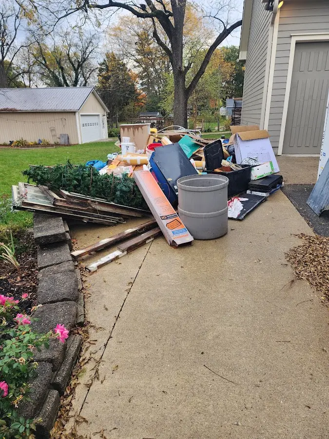 Dumpster being loaded with debris for Commercial Dumpster Rental in Richmond Heights